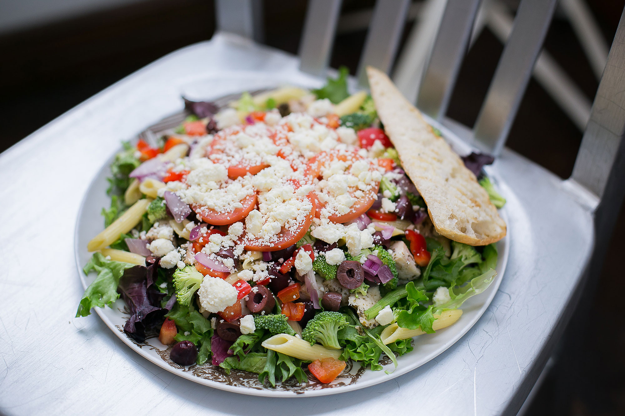 Seasoned chicken breast, tomatoes, red peppers, brocolli, red onions, penne pasta, kalamata olives, feta cheese, vinaigrette dressing